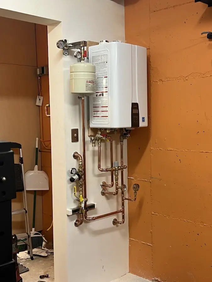 Plumbing technician inspecting water heater connections in Citrus